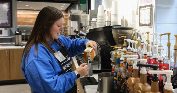 Manager Becca Koch works behind the counter at Brewed Awakening, a student-run coffee shop on the UNK campus. (Photo by Erika Pritchard, UNK Communications)